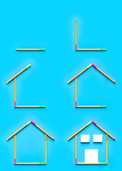 Top view of sticky notes and fluorescent marker pens forming a drawing of a house on pastel blue background, space for text.