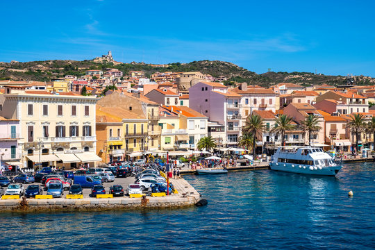 Panoramic view of La Maddalena old town quarter in Sardinia, Italy with port at the Tyrrhenian Sea coastline and island mountains interior in background