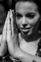 Praying Sign. Young woman with jointed hands in a prayer or meditation. Focus on the fingers.