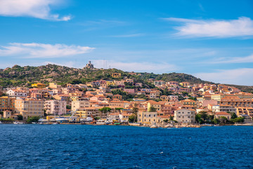 Fototapeta na wymiar Panoramic view of La Maddalena old town quarter in Sardinia, Italy with port at the Tyrrhenian Sea coastline and island mountains interior in background