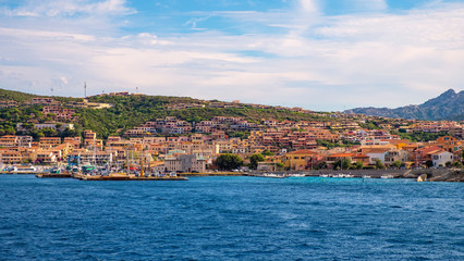 Fototapeta na wymiar Panoramic view of La Maddalena old town quarter in Sardinia, Italy with port at the Tyrrhenian Sea coastline and island mountains interior in background