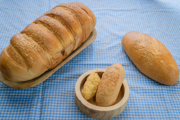Baked breads on wooden table background.
