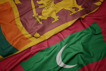 waving colorful flag of maldives and national flag of sri lanka.