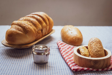 Baked breads on wooden table background.