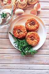 Fried belyashi on a plate. Patties with meat and onions.The traditional dish of Tatar cuisine. Top view. Copy space.