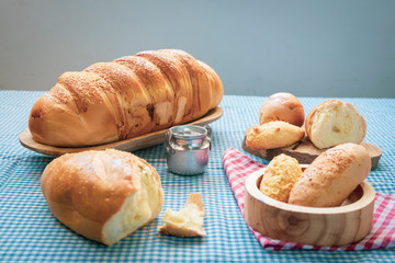 Baked breads on wooden table background.