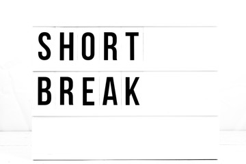 Short Break Sign on Vintage Retro Quote board. Lifestyle 