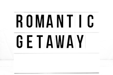 Romantic Getaway travel sign on retro vintage quote board. Love Sign