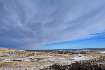 Snow covered road and highway with cloudy sky from Dinosaur Ridge, Colorado, USA