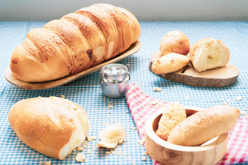 Baked breads on wooden table background.
