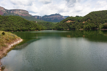 Obraz na płótnie Canvas View of the Sau reservoir at 95% of its capacity with the Collsacabra cliffs in the background. Catalonia, Spain.