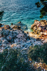 Scenic rocky coastline and turquoise sea of Adriatic sea, Primosten Croatia.Idyllic hidden paradise. Amazing rock cliff seascape background copy space. Travel concept. Vacation destination background.