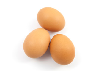 Brown eggs on white background