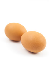 Brown eggs on white background