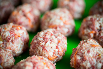 raw meatballs from beef and pork with carrots and rice