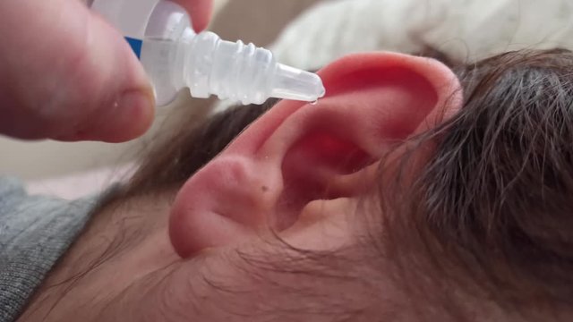close up of a patient with an ear drop for health