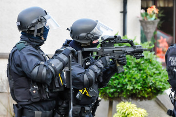 Armed police keep guard at a tense riot situation.