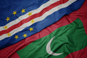 waving colorful flag of maldives and national flag of cape verde.