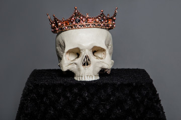 A human skull with a crown lies on the altar.