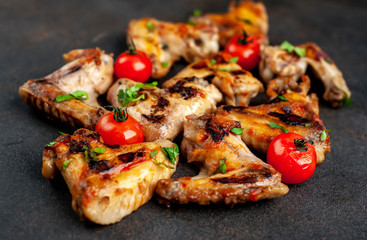 Grilled chicken wings in barbecue sauce on a concrete background