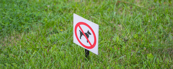 bright sign dogs forbidden on a green lawn