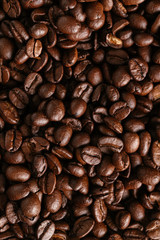 Whole grains of black coffee. Coffee pattern. Top view.