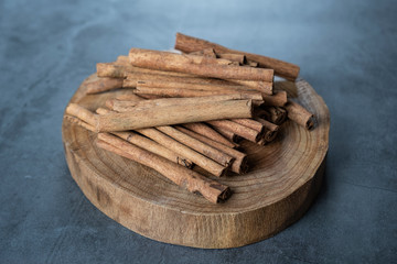 Cinnamon sticks on wooden serving board.