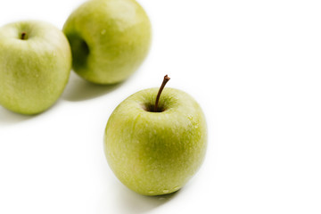 Three green apples on a white isolated background. Top view. 