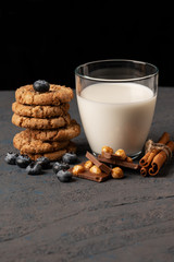 Closeup photo of stack of homemade oatmeal cookies and glass of milk.