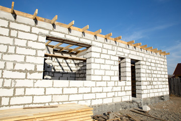 Building site of a house under construction. unfinished house walls made from white aerated autoclaved concrete blocks. outside view.