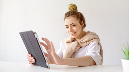 Smiling girl with collected hair works. beautiful student studying on a distance.