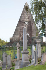 Fototapeta premium Pyramidal and classic tombs at the graveyard of Scottish village