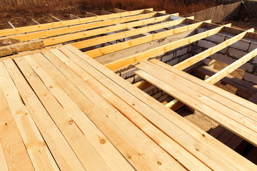 Ceiling beams are made of natural eco-friendly materials. Elements and components of the construction of roof. Construction of a country one-story house.