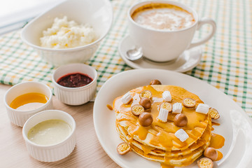 A breakfast with panckakes latte and rice porrige
