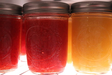 Jars of strawberry and peach jam