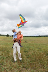 A family flies a kite on the field.