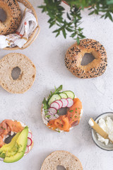 Breakfast flat lay of New York style bagels with philadelphia cheese, avocado, cured salmon