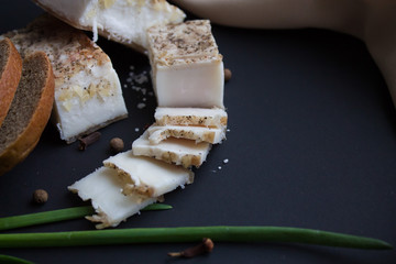 Bread with salted bacon and onions. Garlic on the table. Lunch, dinner. Meal.