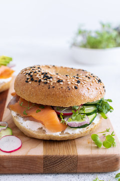 Close-up of fresh baked breakfast or brunch bagel with philadelphia cheese, cured salmon and microgreens