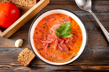 plate of russian red borscht with parsley  ,  spoon, top view