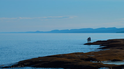 two women silhouetted, lake superior