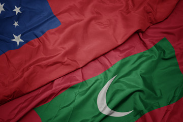 waving colorful flag of maldives and national flag of Samoa .