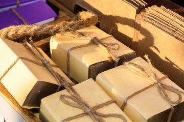 Soaps artisans, detail of soaps for body wash. Bar of natural artisan made Marseilles aromatherapy bath soap with potpourri for a pampering cleansing session in a spa