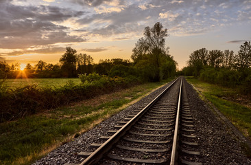 Old railroad tracks at sunset