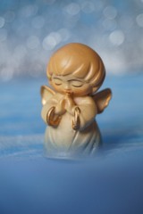 Guardian angel - wooden angel on a blue background