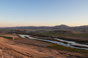 snake river and owyhees in background during sunset on a spring evening in southern idaho