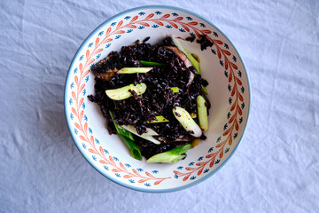 Healthy Vegan Food, Black Rice with baked mushrooms and spring onions.