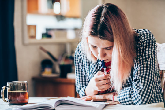  girl performs a school task at home-distance learning during the coronavirus pandemic