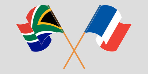 Crossed and waving flags of South Africa and France