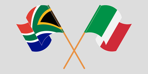 Crossed and waving flags of South Africa and Italy